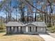 Charming one-story home with updated siding and trim and a well-manicured lawn at 8329 Marlborough Dr, Jonesboro, GA 30238