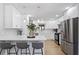 Bright kitchen featuring white cabinets, stainless steel appliances, and a breakfast bar at 8329 Marlborough Dr, Jonesboro, GA 30238