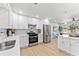 Open-concept kitchen with modern appliances seamlessly flowing into living area at 8329 Marlborough Dr, Jonesboro, GA 30238