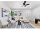 Bright living room featuring modern decor, ceiling fan, and natural light at 8329 Marlborough Dr, Jonesboro, GA 30238