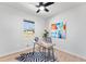 A simple office featuring wood floors, a ceiling fan, and a colorful abstract piece of art at 8329 Marlborough Dr, Jonesboro, GA 30238