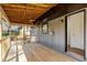 Spacious wooden porch area featuring an overhead ceiling and open entry way into the home at 8329 Marlborough Dr, Jonesboro, GA 30238