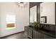 Spa-like bathroom featuring a double vanity with dark countertop, modern lighting, and a large window at 1041 Walker Se Ave, Atlanta, GA 30316