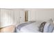 Cozy bedroom with a white four-poster bed, wood floors, closet, and access to another room at 1041 Walker Se Ave, Atlanta, GA 30316
