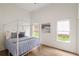 Bright bedroom with a four poster bed, wood floors, white walls, and natural light from two windows at 1041 Walker Se Ave, Atlanta, GA 30316