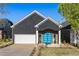 Charming one-story home featuring a striking blue front door and modern architectural details at 1041 Walker Se Ave, Atlanta, GA 30316