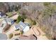 Aerial view of a home nestled in a wooded area with a spacious yard, showcasing its serene and private location at 105 Condor Ct, Woodstock, GA 30188