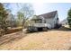 Expansive backyard with a large deck and mature trees providing shade and privacy, creating a serene outdoor space at 105 Condor Ct, Woodstock, GA 30188