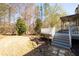 View of the deck and backyard featuring mature trees and lush greenery, perfect for outdoor enjoyment at 105 Condor Ct, Woodstock, GA 30188