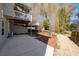 Backyard featuring a deck, patio, and mature trees, creating a perfect space for outdoor relaxation and entertainment at 105 Condor Ct, Woodstock, GA 30188