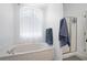 Bright bathroom with a large bathtub and a glass-enclosed shower at 105 Condor Ct, Woodstock, GA 30188