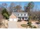 Charming front exterior of a two-story home featuring a well-manicured lawn, two-car garage, and inviting curb appeal at 105 Condor Ct, Woodstock, GA 30188