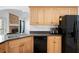 Well-lit kitchen with stainless steel sink, black appliances and light colored cabinets at 105 Condor Ct, Woodstock, GA 30188
