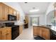 Well-lit kitchen with light wood cabinets, tile floors, and modern appliances at 105 Condor Ct, Woodstock, GA 30188