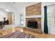 Cozy living room showcasing a stone fireplace, hardwood floors and bright light at 105 Condor Ct, Woodstock, GA 30188