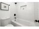 Modern bathroom features a subway-tiled shower over tub, and brushed bronze fixtures and hardware at 2860 3Rd Sw Ave, Atlanta, GA 30315
