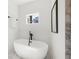 Bright bathroom featuring a modern tub, sleek black hardware, and an abundance of natural light at 2860 3Rd Sw Ave, Atlanta, GA 30315