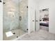 Bright bathroom featuring marble walk-in shower with glass enclosure and a view to an adjacent bedroom at 2860 3Rd Sw Ave, Atlanta, GA 30315