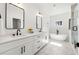 Bright, modern bathroom with double vanity, soaking tub, glass-enclosed shower, and marble flooring at 2860 3Rd Sw Ave, Atlanta, GA 30315