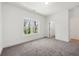Bright, carpeted bedroom with a large window, white trim, and a doorway to an adjacent room at 2860 3Rd Sw Ave, Atlanta, GA 30315