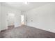 A modern bedroom with plush carpeting, white trim, and multiple doors to closets and other rooms at 2860 3Rd Sw Ave, Atlanta, GA 30315