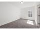 Sunlit bedroom with plush carpeting, white trim, and a window showcasing natural light and a neutral palette at 2860 3Rd Sw Ave, Atlanta, GA 30315