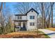Charming two-story modern farmhouse with white siding, black trim, covered porch, and well-manicured landscaping at 2860 3Rd Sw Ave, Atlanta, GA 30315