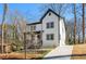 Side view of a charming two-story modern farmhouse with white siding, black trim and a concrete driveway at 2860 3Rd Sw Ave, Atlanta, GA 30315