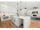 Bright, open kitchen with white cabinets, a farmhouse sink, island seating, and hardwood floors at 2860 3Rd Sw Ave, Atlanta, GA 30315