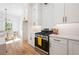 Modern kitchen with white cabinets, stainless steel appliances, and eat-in dining area at 2860 3Rd Sw Ave, Atlanta, GA 30315