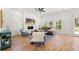 Open-concept living room with fireplace, wood floors, and abundant natural light at 2860 3Rd Sw Ave, Atlanta, GA 30315