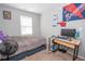 Bedroom with a bed and a desk set up as a gaming station at 6338 Kinsland Ct, Lithonia, GA 30058