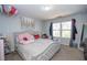 Cozy bedroom featuring a soft bed, natural light, and decorative accents at 6338 Kinsland Ct, Lithonia, GA 30058