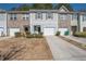 Inviting townhome with a one-car garage and well-maintained front yard at 6338 Kinsland Ct, Lithonia, GA 30058