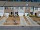 Charming townhome featuring attached garage, neutral siding, and landscaping at 6338 Kinsland Ct, Lithonia, GA 30058