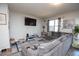 Comfortable living room featuring a large sectional sofa, decorative rug, and a mounted television at 6338 Kinsland Ct, Lithonia, GA 30058