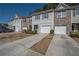 Charming townhome exteriors with driveways and manicured landscaping at 6338 Kinsland Ct, Lithonia, GA 30058