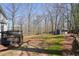 A spacious backyard with a deck, shed, gazebo, and mature trees offering a great view at 4460 Wimberly Way, Cumming, GA 30028
