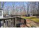 Large backyard with an expansive deck, patio dining set, storage shed, and mature trees at 4460 Wimberly Way, Cumming, GA 30028