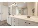 Well-lit bathroom featuring a double vanity, shower, and modern laminate flooring at 4460 Wimberly Way, Cumming, GA 30028