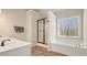 Bright bathroom with a shower, soaking tub, and double vanity with laminate flooring at 4460 Wimberly Way, Cumming, GA 30028