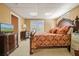Bedroom with an ornate wood bed frame, matching dresser, and double French doors to the outside at 4460 Wimberly Way, Cumming, GA 30028