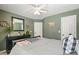 Bedroom with olive green walls, natural wood decor and comfortable gray bedding at 4460 Wimberly Way, Cumming, GA 30028