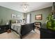 Cozy bedroom with olive green walls, ceiling fan, and elegant black furniture at 4460 Wimberly Way, Cumming, GA 30028