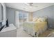 Light-filled bedroom with white furniture, yellow accents, and a serene atmosphere at 4460 Wimberly Way, Cumming, GA 30028