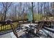 Outdoor dining set with umbrella on spacious wood deck overlooking wooded backyard at 4460 Wimberly Way, Cumming, GA 30028