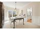 Bright dining room features a modern chandelier, large windows with views, and neutral decor at 4460 Wimberly Way, Cumming, GA 30028