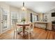 Bright dining area features hardwood floors, a round wood table, white chairs, and views of the outdoor space at 4460 Wimberly Way, Cumming, GA 30028