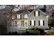 Charming two-story home with gray siding, front porch, and manicured landscaping at 4460 Wimberly Way, Cumming, GA 30028
