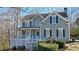 Charming two-story home featuring a welcoming front porch and meticulously manicured landscaping at 4460 Wimberly Way, Cumming, GA 30028